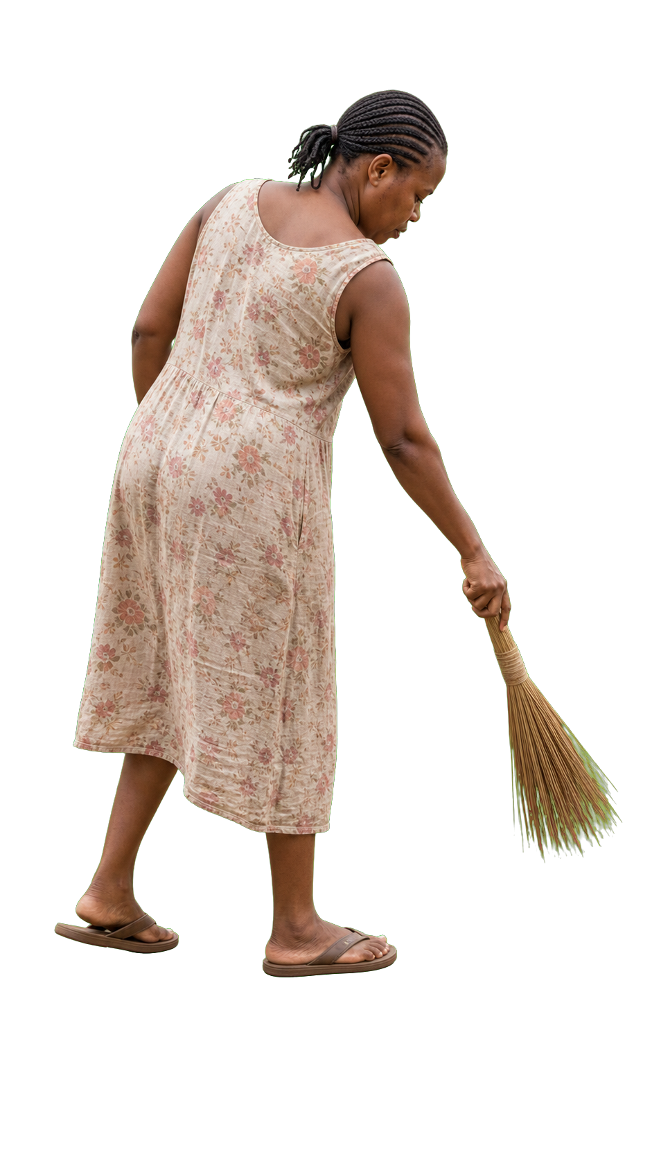 African woman sweeping with small traditional broom