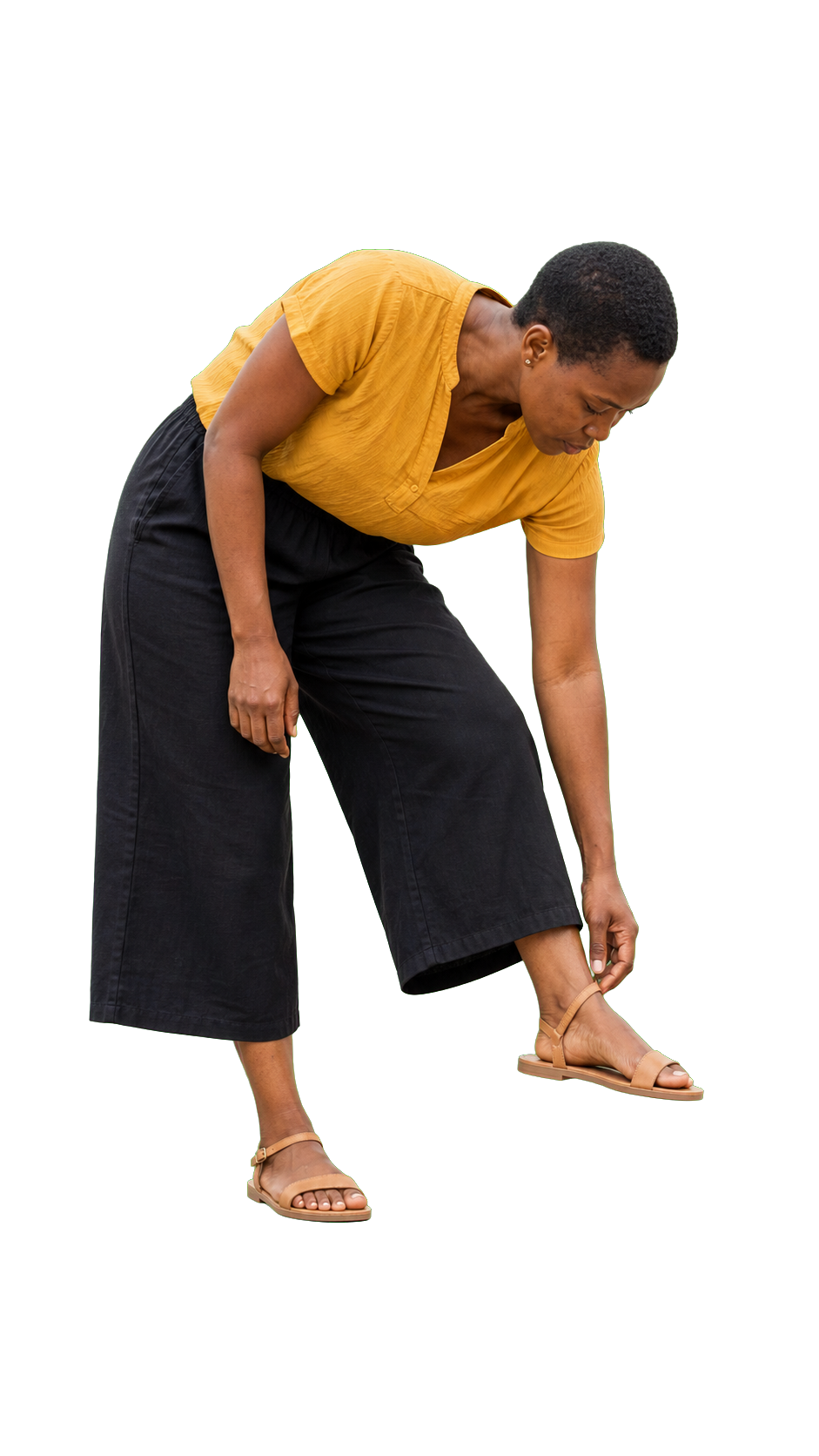 African woman adjusting sandal standing