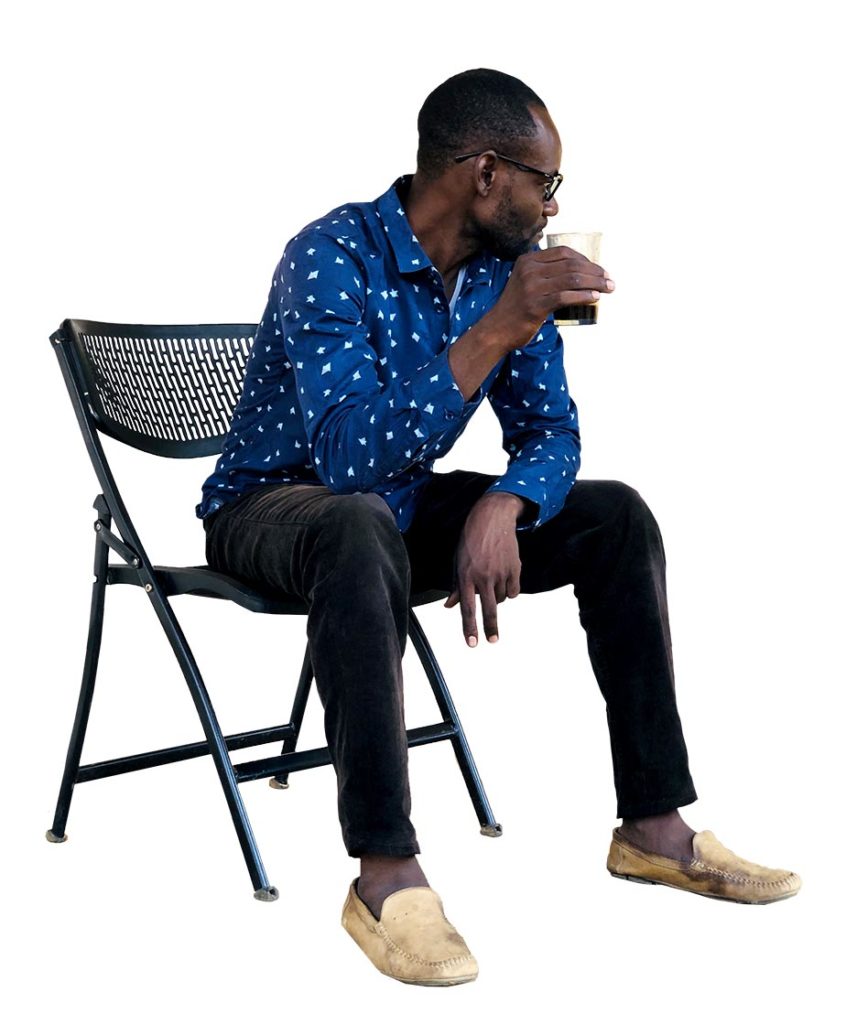 African Man Sitting on a chair drinking coffee